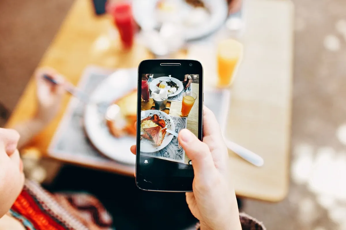 A diner photographing a colorful spread of dishes, the food searches your menu helps you match