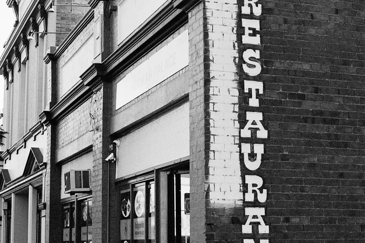 A restaurant storefront and sign, one of the many brand touchpoints a guest meets