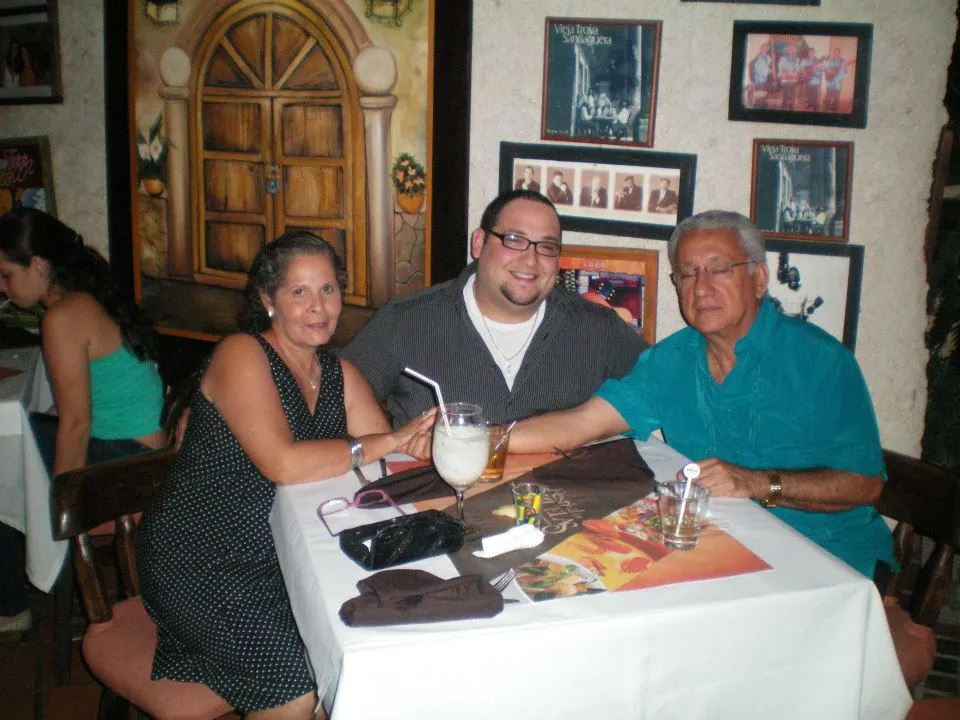 Daniel Ruiz at a restaurant table with his parents