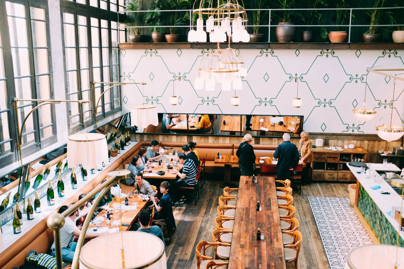 A bright, busy modern restaurant dining room full of guests