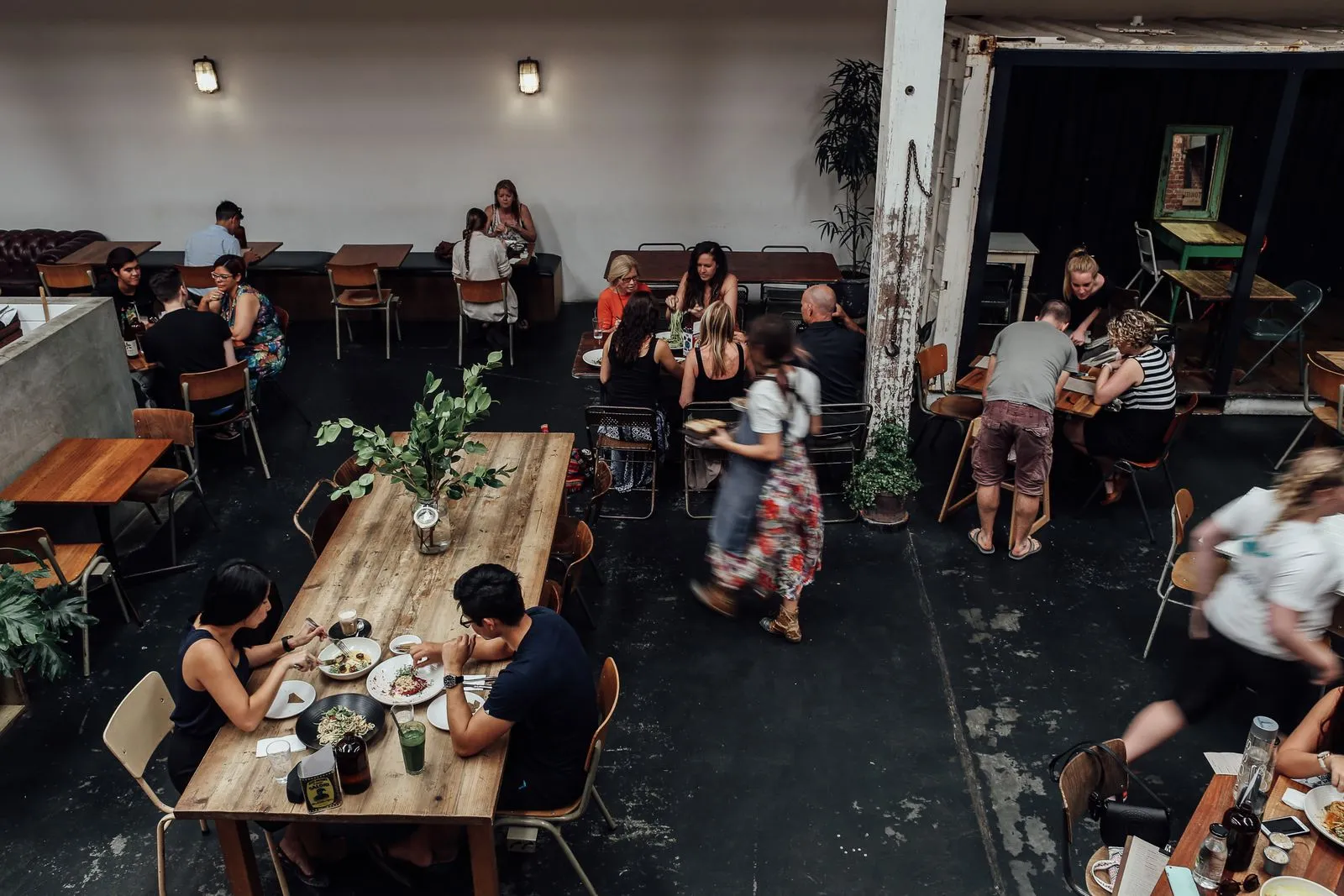 A bright dining room full of happy guests