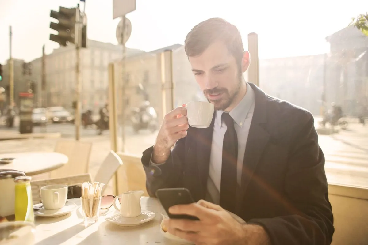 A regular checking an email from a restaurant over coffee